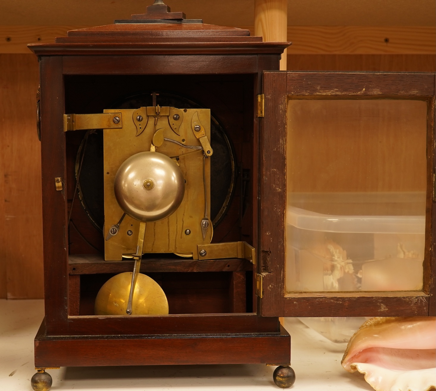 An early 19th century rosewood and brass bracket clock, striking on a bell, with pendulum and key, 47cm high
